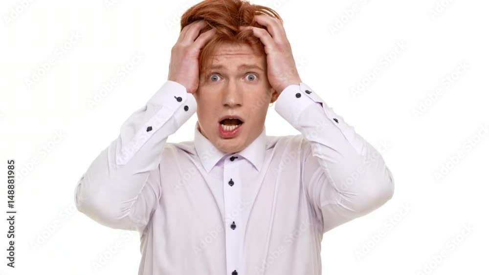 Ginger handsome Caucasian young man suddenly get scared on white background Ginger handsome Caucasian young man suddenly get scared on white background