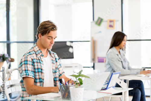 Young man working in office © Sergey Nivens