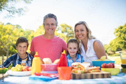 Portrait of happy family having meal in park