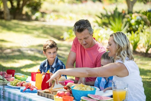 Happy family having meal in park