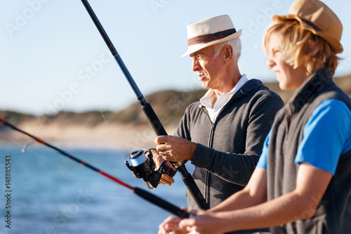 Senior man fishing with his grandson © Sergey Nivens