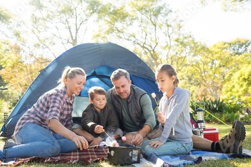 Canvas Print Family roasting marshmallows outside the tent