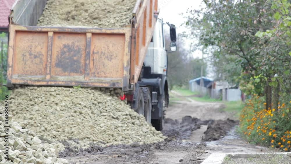 Pouring a Tipper sand on the road Pouring a Tipper sand on the road