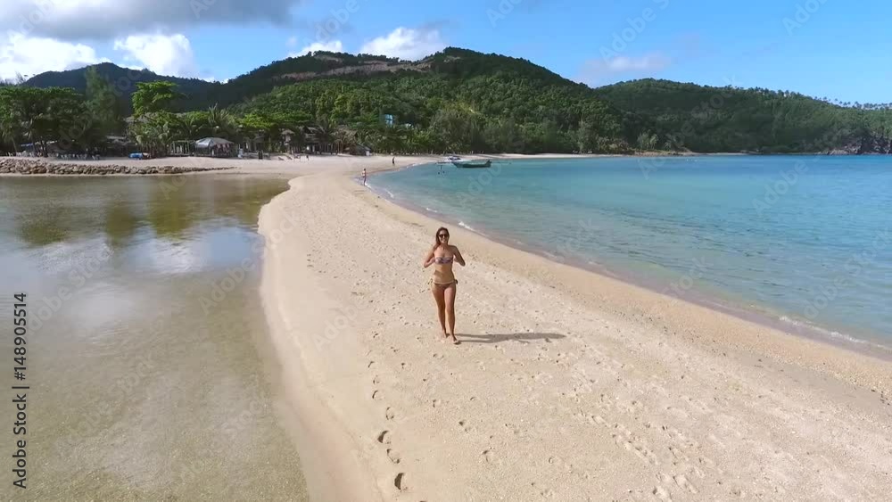 Happy Gorgeous Woman in Bikini Walking on the Beach. Koh Phangan, Thailand. Aerial HD Slowmotion. Happy Gorgeous Woman in Bikini Walking on the Beach. Koh Phangan, Thailand. Aerial HD Slowmotion.