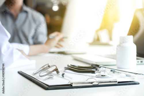 Healthcare and Medical concept, patient listening intently to a female doctor explaining patient symptoms or asking a question as they discuss paperwork together in a consultation