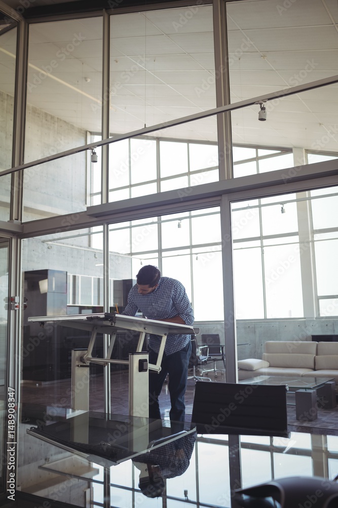 Fototapeta premium Male interior designer drawing on workbench in office 