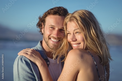 Thoughtful couple hugging at beach