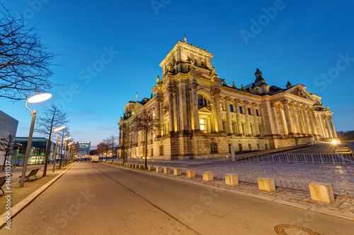 The famous german Reichstag in Berlin illuminated before sunrise