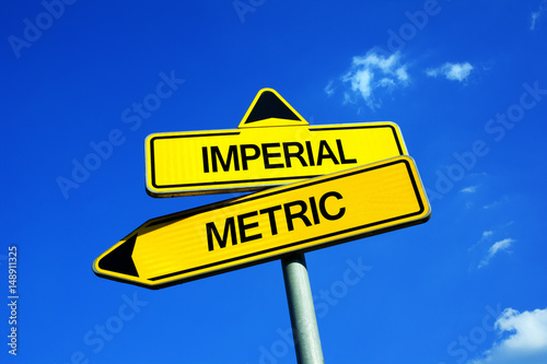 Imperial vs Metric - Traffic sign with two options - measure units in metres and litres or measuring weight and length in feets, inches and gallons. Britisn and American versus European units photo