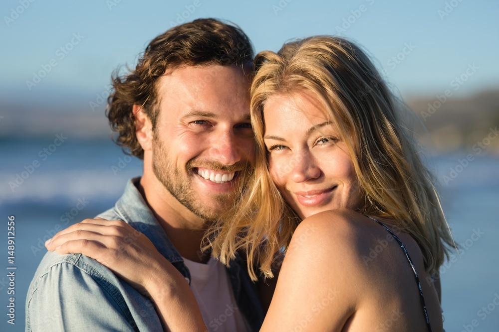 Portrait of happy couple hugging at beach Portrait of happy couple hugging at beach