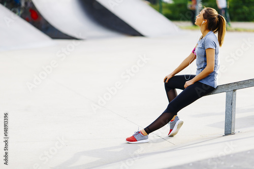 Young woman relaxing during exercise in the park