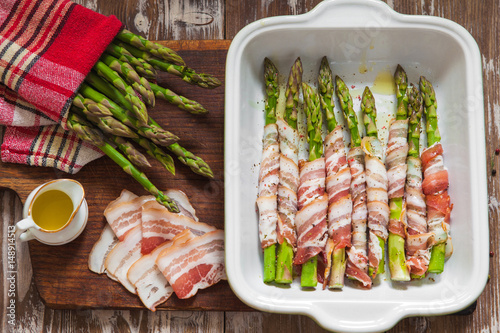 Baked green asparagus wrapped with bacon photo