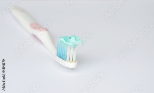 toothpaste put on toothbrush in white background