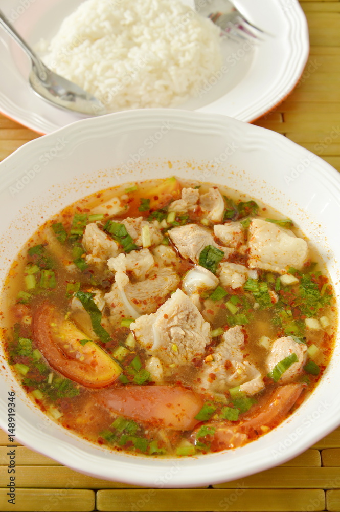 hot and spicy pork bone tamarind and Thai herbs soup eat couple with rice