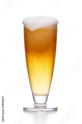 Misted glass of light beer on white.