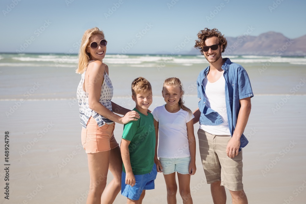 Portrait of smiling family standing at beach Portrait of smiling family standing at beach