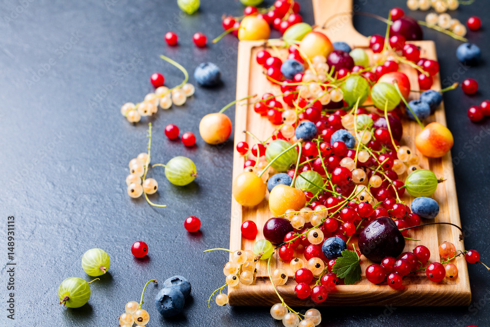 Fresh berries on wooden cutting board. Copy space Fresh berries on wooden cutting board. Copy space