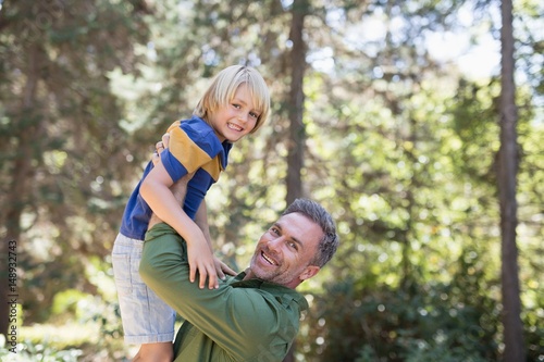 Portrait of playful father lifting up son 
