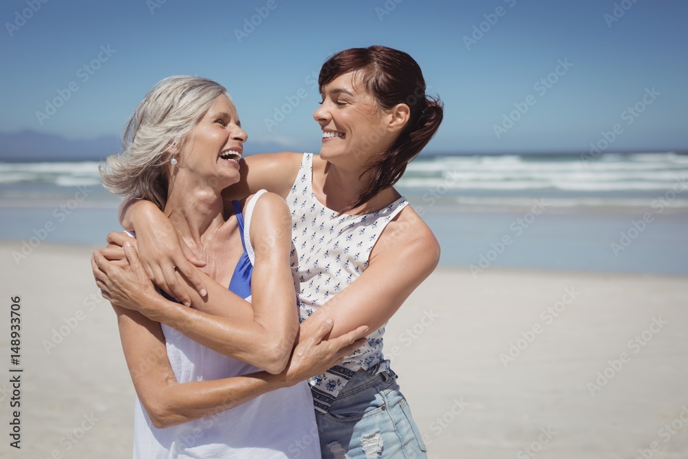 Happy woman with her mother standing at beach Happy woman with her mother standing at beach