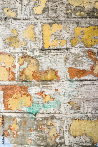 Grungy old paint on brick wall.