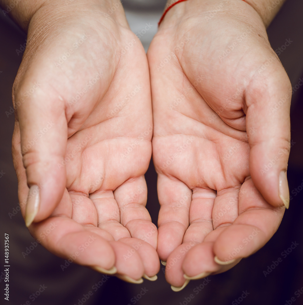 People, charity and poverty concept - close up of female empty cupped hands holding and showing something People, charity and poverty concept - close up of female empty cupped hands holding and showing something