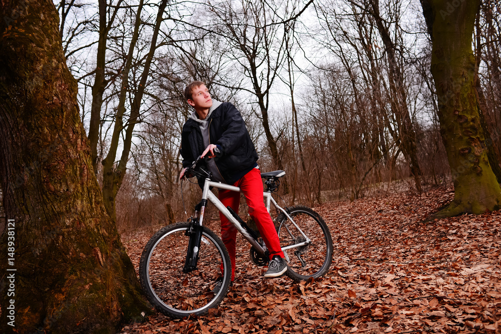 Cyclist Riding the Bike on a Trail in Summer Forest Cyclist Riding the Bike on a Trail in Summer Forest