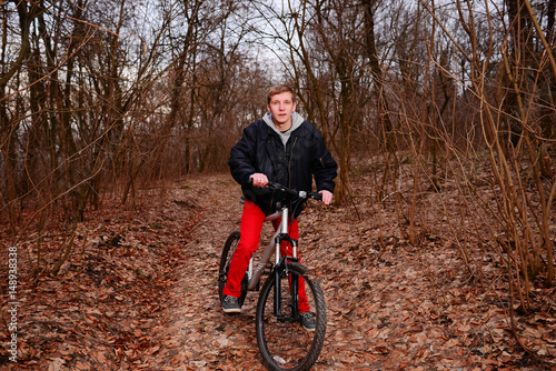 Cyclist Riding the Bike on a Trail in Summer Forest © cezarksv