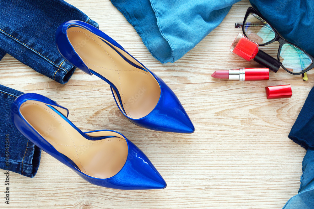Jeans, shoes and perfume on the wooden background Jeans, shoes and perfume on the wooden background