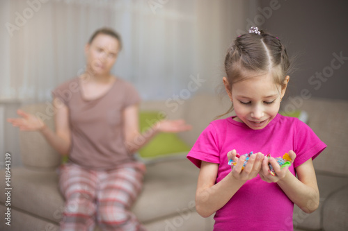 Mother frustrating that her daughter eat many candies.
