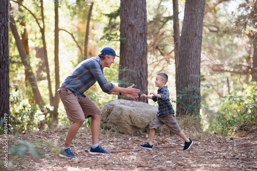 Playful father and son hiking in forest © WavebreakMediaMicro