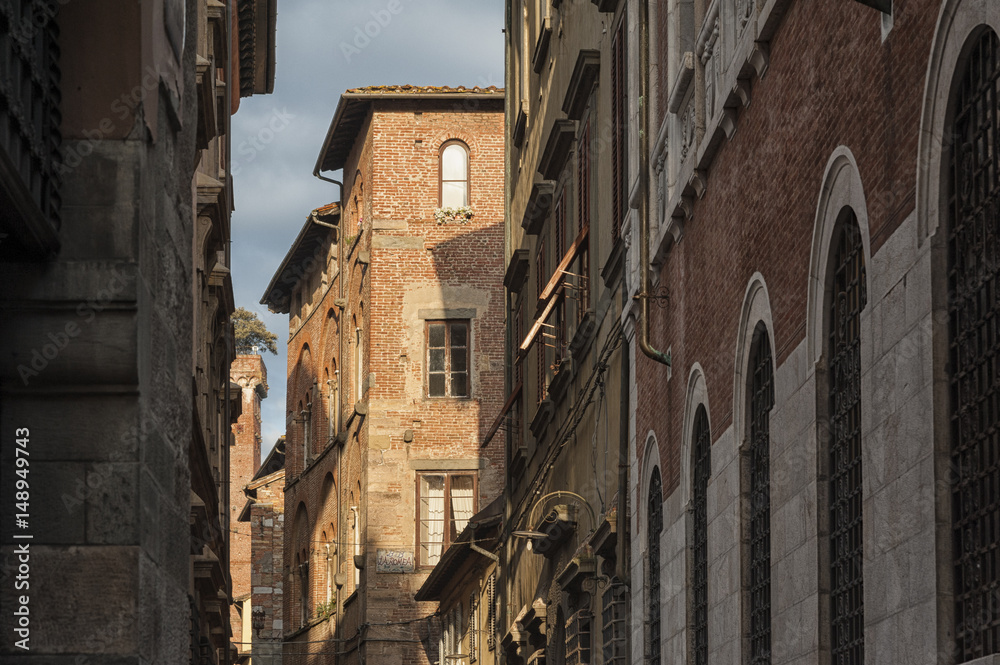 Narrow street with typical italian houses in Lucca, Tuscany, Italy