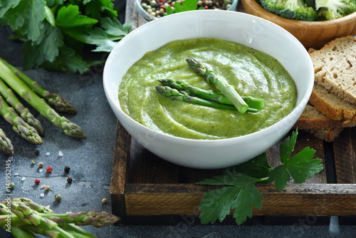 Green vegetable cream soup, with asparagus, vegan, vegetarian eating, dieting, healthy food
