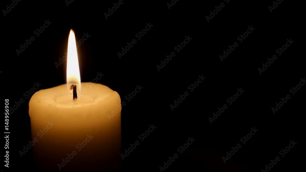 Lit White Candle Over Black Background.