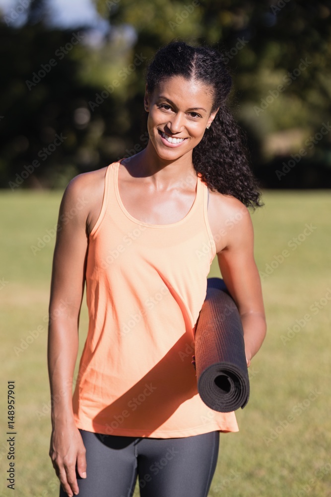 Portrait of happy woman holding exercise mat Portrait of happy woman holding exercise mat