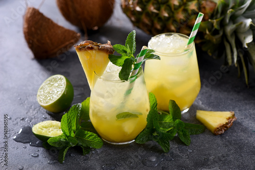 Cold pineapple cocktail with crushed ice, lime and mint, refreshing lemonade drink