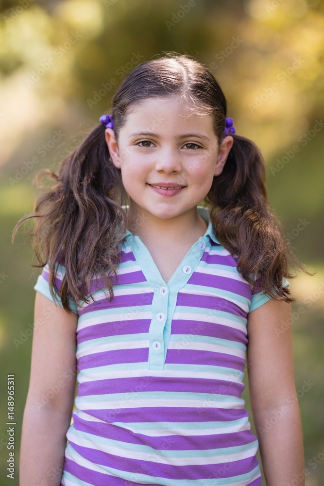 Smiling little girl standing in forest Smiling little girl standing in forest