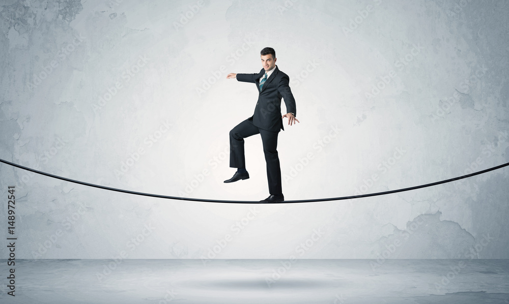Sales guy balancing on tight rope Sales guy balancing on tight rope