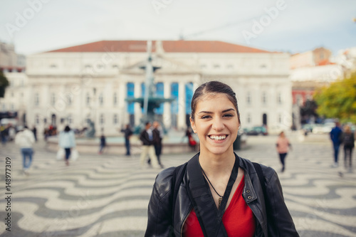 Enjoying Europe capital travel.Young traveler woman admiring beautiful Rossio square in Lisbon,Portugal.Energetic,dynamic day in cobblestoned Lisbon center streets.Travel blogger experiencing amazing photo