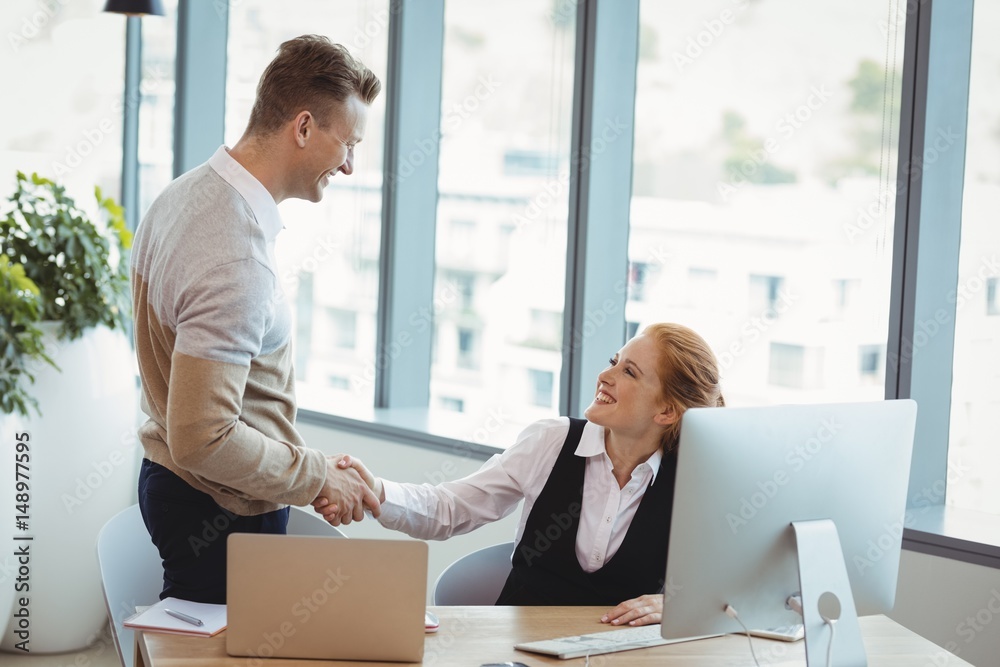 Smiling executives shaking hands Smiling executives shaking hands