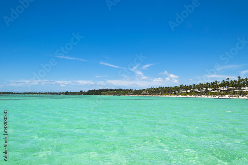 Equatorial part of the ocean with turquoise water, tropical island background