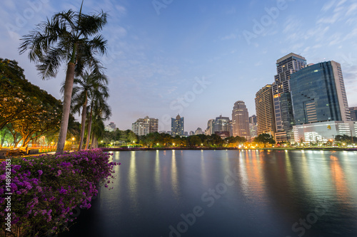 Scenic view of the Benjakiti (Benjakitti) Park and lit buildings in Bangkok, Thailand, in the evening. © tuomaslehtinen