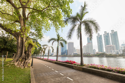 Jogging path at the Benjakiti (Benjakitti) Park and modern skyscrapers in Bangkok, Thailand. photo