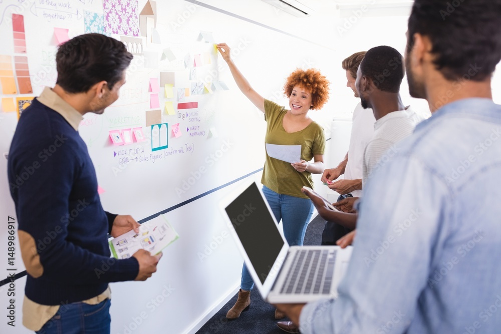 © WavebreakMediaMicro - People looking at colleague explaining plan