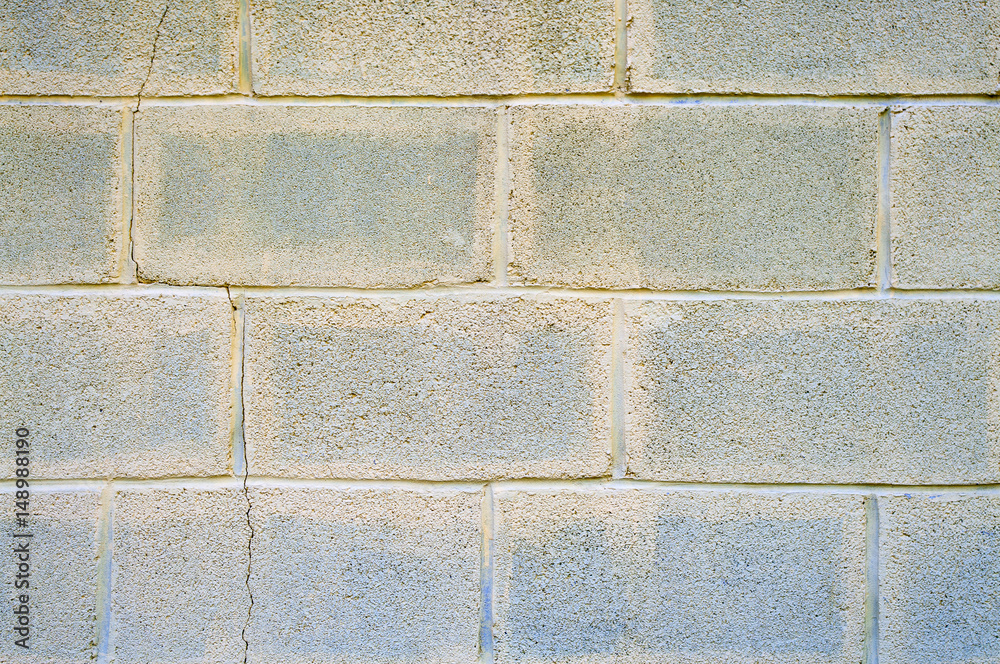 Fototapeta premium Cinder block wall with cracks