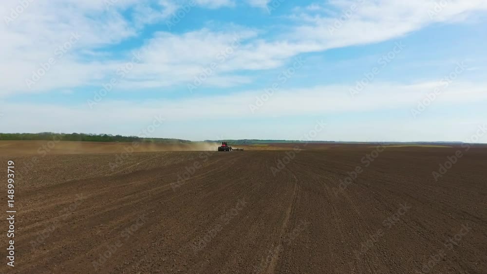 Farmer in tractor preparing land for sowing Farmer in tractor preparing land for sowing