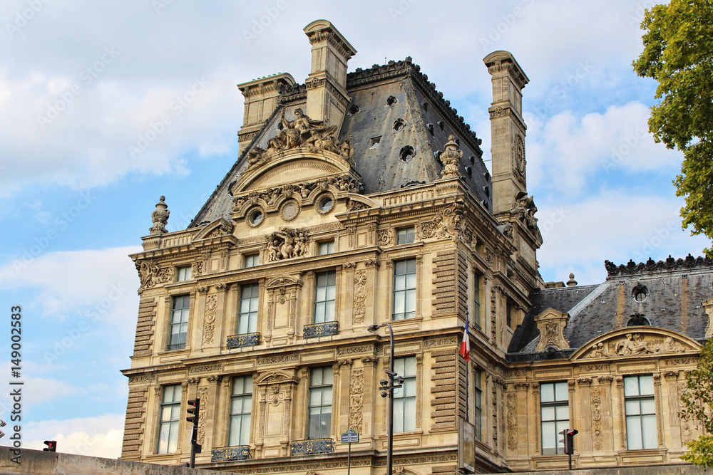 Fototapeta premium View on Louvre museum building, blue sky with white clouds, paris city, france
