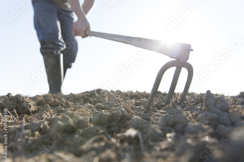man hoeing farmland