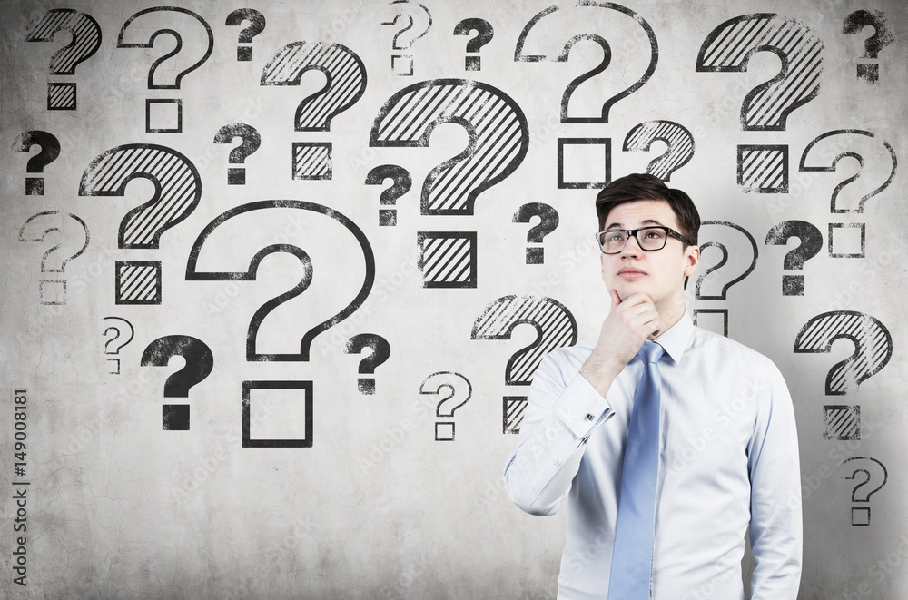 Man in glasses and many question marks Man in glasses and many question marks