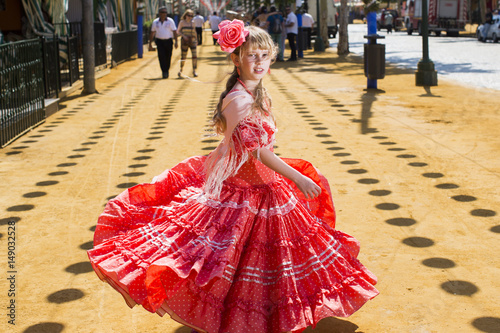 women in traditional flamenco dresses dance during the Feria de Abril on April Spain