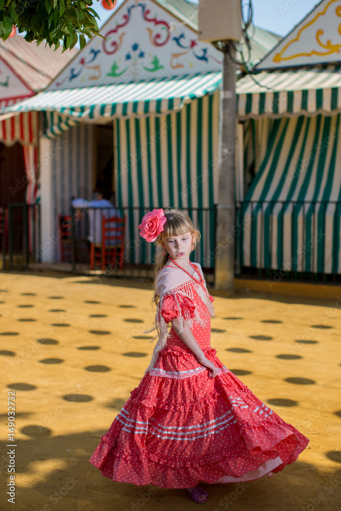Fototapeta premium Little girls in flamenco style dress at the Sevilla, Spain. Seville's April Fair on April